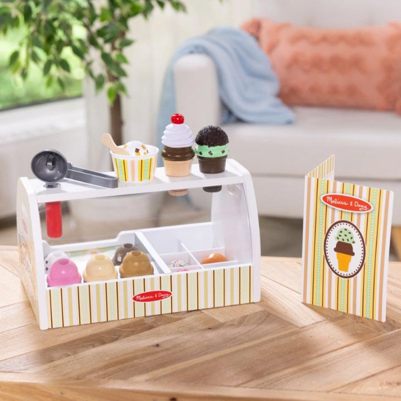 Melissa & Doug Ice Cream Counter showing scoops, cones, and toppings organized in counter
